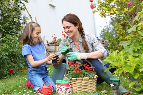 Team of gardeners at work with equipment in a residential garden
